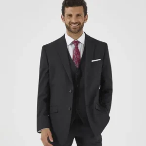Man in a black suit with a white shirt, red tie, and white pocket square, posing for a formal wear photo.